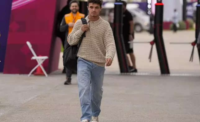 McLaren driver Lando Norris of Britain walks through paddock as he arrives at the Lusail International Circuit in Lusail, Qatar, ahead of the Qatar Grand Prix, Thursday, Nov. 28, 2024. (AP Photo/Darko Bandic)