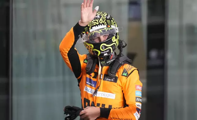 McLaren driver Lando Norris of Britain waves after winning the pole position during sprint qualifying at the Lusail International Circuit in Lusail, Qatar, ahead of the Qatar Formula One Grand Prix, Friday, Nov. 29, 2024. (AP Photo/Darko Bandic, Pool)