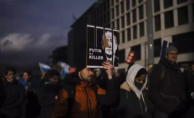 People attend a demonstration under the slogan "Stop Putin! Stop the War! Freedom for Political Prisoners!" in Berlin, Germany, Sunday, Nov. 17, 2024. (AP Photo/Markus Schreiber)