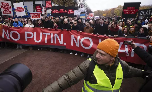 Yulia Navalnaya, center, leads with Russian opposition politician Vladimir Kara-Murza, center left, and Ilya Yashin, center right, a demonstration under the slogan "Stop Putin! Stop the War! Freedom for Political Prisoners!" in Berlin, Germany, Sunday, Nov. 17, 2024. (AP Photo/Markus Schreiber)