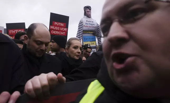 Yulia Navalnaya, center, with Russian opposition politician Vladimir Kara-Murza, left, lead a demonstration under the slogan "Stop Putin! Stop the War! Freedom for Political Prisoners!" in Berlin, Germany, Sunday, Nov. 17, 2024. (AP Photo/Markus Schreiber)