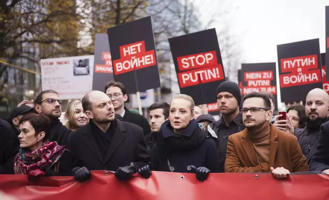 Yulia Navalnaya, center, with Russian opposition politician Vladimir Kara-Murza, center left, and Ilya Yashin, center right, lead a demonstration under the slogan "Stop Putin! Stop the War! Freedom for Political Prisoners!" in Berlin, Germany, Sunday, Nov. 17, 2024. (AP Photo/Markus Schreiber)