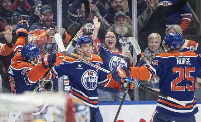 Edmonton Oilers' Connor McDavid (97) celebrates his 1000th point, against the Nashville Predators during the second period of an NHL hockey game, Thursday, Nov. 14, 2024 in Edmonton, Alberta. (Jason Franson/The Canadian Press via AP)