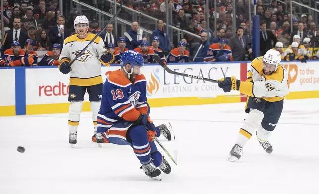 Nashville Predators' Roman Josi (59) has his shot blocked by Edmonton Oilers' Adam Henrique (19) during the first period of an NHL hockey game, Thursday, Nov. 14, 2024 in Edmonton, Alberta. (Jason Franson/The Canadian Press via AP)