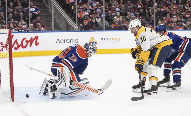 Nashville Predators' Cole Smith (36) scores on Edmonton Oilers goalie Calvin Pickard (30) during the third period of an NHL hockey game, Thursday, Nov. 14, 2024 in Edmonton, Alberta. (Jason Franson/The Canadian Press via AP)