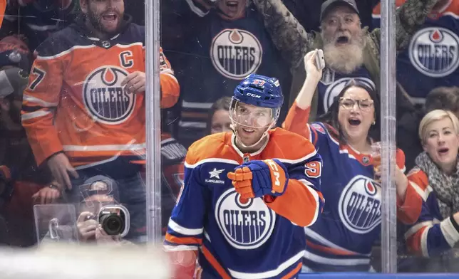 Edmonton Oilers' Connor McDavid (97) celebrates his 1000th point, against the Nashville Predators during the second period of an NHL hockey game, Thursday, Nov. 14, 2024 in Edmonton, Alberta. (Jason Franson/The Canadian Press via AP)