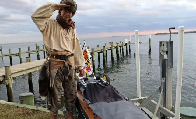 Peter Frank stands by his canoe in Annapolis, Md., on Thursday, Nov. 7, 2024, a day before he plans to resume his trip along the Great Loop in what is roughly a 6,000-mile voyage and that he estimates will take him a total of about 17 months. (AP Photo/Brian Witte)