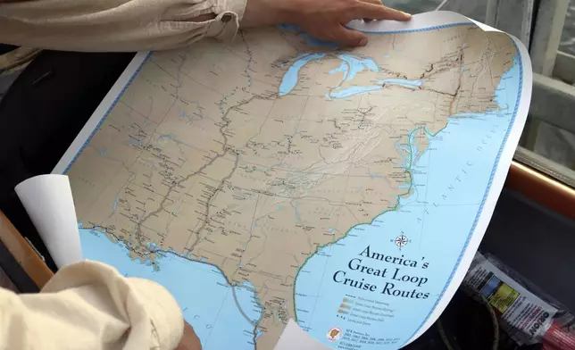 Peter Frank holds a map Thursday, Nov. 7, 2024, of the Great Loop, a 6,000-mile journey he is trying to complete in a canoe, during a stop in Annapolis, Md. (AP Photo/Brian Witte)