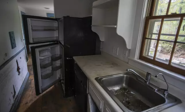 The kitchen in the flood-damaged home of John and Jenny Mackenzie is shown on Sept. 23, 2024 in Peacham, Vt. (AP Photo/Dmitri Beliakov)