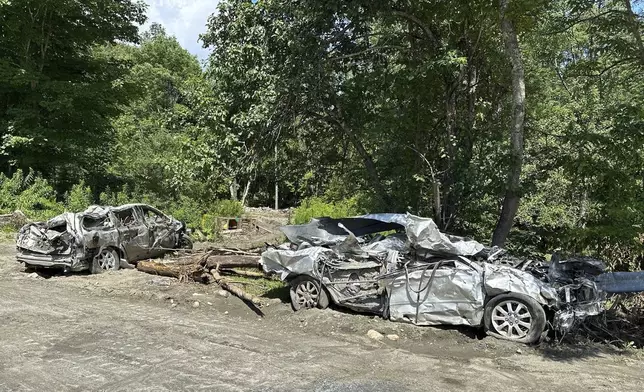 The Mackenzie family's flooded-destroyed cars are shown in Peacham, Vt. on July 18, 2024. (AP Photo/Lisa Rathke)