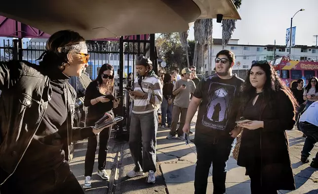 Movie fans pick out tee-shirts during a merchandise Pop-Up event for the newly released film Anora on Saturday, Nov. 9, 2024 in Los Angeles. (AP Photo/Richard Vogel)