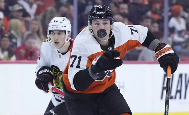 Philadelphia Flyers' Tyson Foerster, right, reaches for the puck past Chicago Blackhawks' Ilya Mikheyev during the second period of an NHL hockey game, Saturday, Nov. 23, 2024, in Philadelphia. (AP Photo/Matt Slocum)