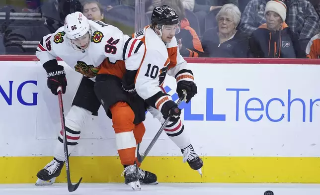 Chicago Blackhawks' Ilya Mikheyev, left, and Philadelphia Flyers' Bobby Brink collide during the second period of an NHL hockey game, Saturday, Nov. 23, 2024, in Philadelphia. (AP Photo/Matt Slocum)