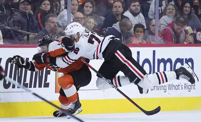 Chicago Blackhawks' Alex Vlasic, right, collides with Philadelphia Flyers' Travis Konecny during overtime in an NHL hockey game, Saturday, Nov. 23, 2024, in Philadelphia. (AP Photo/Matt Slocum)