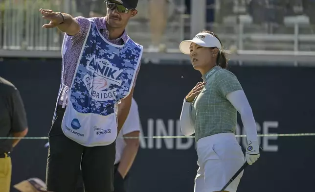 Jiwon Jeon, right, of South Korea, talks with her caddy on the first tee during the first round of The Annika golf tournament at Pelican Golf Club, Thursday, Nov. 14, 2024, in Belleair, Fla. (AP Photo/Steve Nesius)