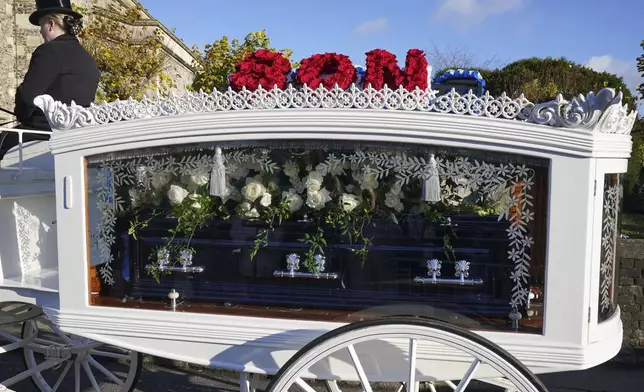 A horse-drawn carriage carrying the coffin of Liam Payne arrives for the funeral service of the One Direction singer at St Mary's Church in Amersham, Buckinghamshire, England, Wednesday Nov. 20, 2024. (Jonathan Brady/PA via AP)