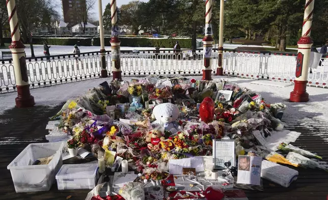 Flowers, portraits and toys lay in the ground for memory of the One Direction star singer Liam Payne at a memorial in West Park in his hometown of Wolverhampton, England, Wednesday, Nov. 20, 2024. (Jacob King/PA via AP)