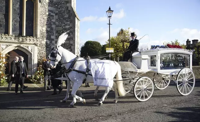 A horse-drawn carriage carrying the coffin of Liam Payne arrives for the funeral service of the One Direction singer at St Mary's Church in Amersham, Buckinghamshire, England, Wednesday Nov. 20, 2024. (Andrew Matthews/PA via AP)