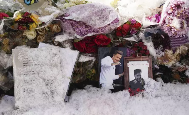 Floral tributes to singer Liam Payne at a memorial in West Park in his hometown of Wolverhampton, England, Wednesday, Nov. 20, 2024. (Jacob King/PA via AP)