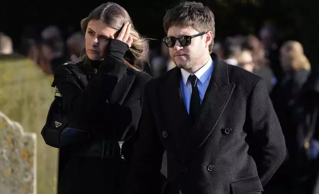 Niall Horan, right, walks after the funeral service for One Direction singer Liam Payne at St Mary's Church in Amersham, England, Wednesday, Nov. 20, 2024. (Andrew Matthews/PA via AP)