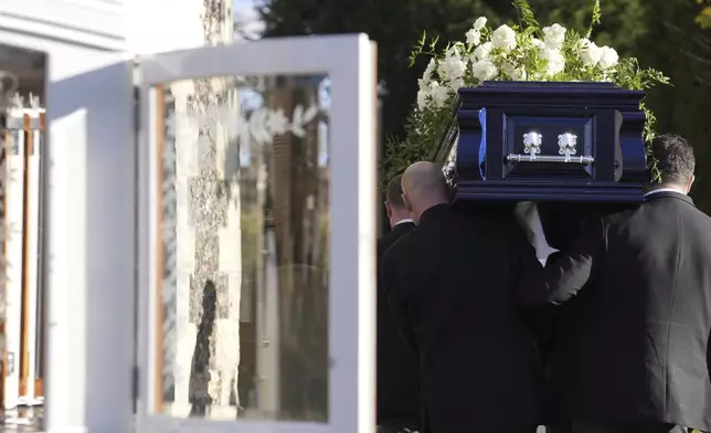 Liam Payne's coffin is carried into the funeral service for the One Direction singer at St Mary's Church in Amersham, Buckinghamshire, England, Wednesday Nov. 20, 2024. (Andrew Matthews/PA via AP)