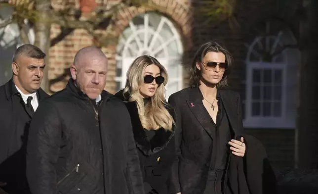 Damian Hurley, right, and Kate Cassidy, second right, arrives the funeral service of One Direction singer Liam Payne at St Mary's Church in Amersham, England, Wednesday, Nov. 20, 2024. (Andrew Matthews/PA via AP)