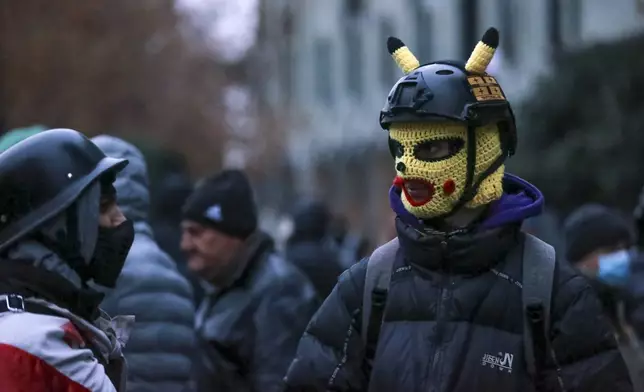 Protesters gather in a street during a rally to demand new parliamentary elections in the country, near the Parliament's building in Tbilisi, Georgia, on Monday, Nov. 25, 2024. (AP Photo/Zurab Tsertsvadze)