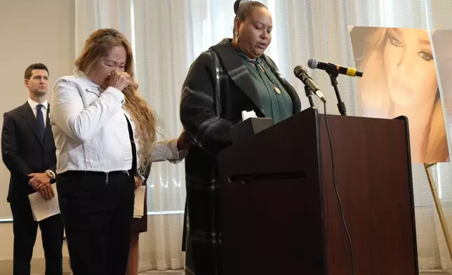 Adriana Vance, mother of Raymond Green who was killed in the Club Q nightclub mass shooting in Colorado Springs, Colo., talks about her son as grandmother Estela Bell, left, cries during a news conference announcing the filing of a civil complaint on the two-year anniversary of the deadly mass shooting, Tuesday, Nov. 19, 2024, in Denver. (AP Photo/Jack Dempsey)