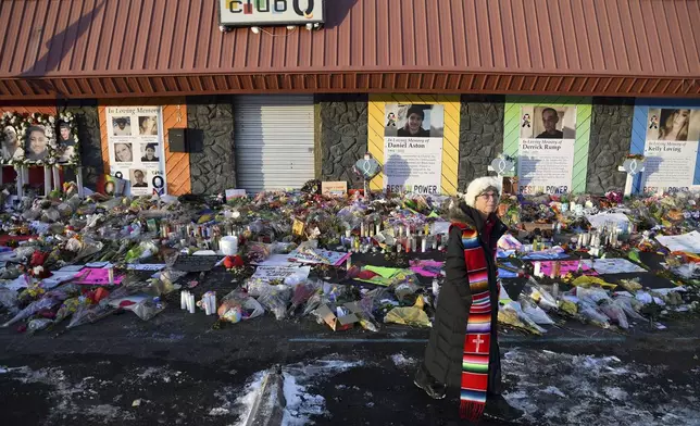 FILE - Rev. Paula Stecker of the Christ the King Lutheran Church stands in front of a memorial set up outside Club Q following a mass shooting at the gay nightclub in Colorado Springs, Colo., Nov. 29, 2022. (AP Photo/Thomas Peipert, File)