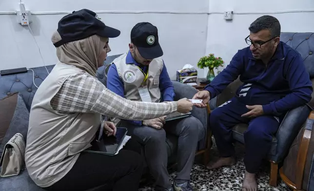 Workers prepare to collect information from the public as Iraq began its first nationwide population census in decades, in Baghdad, Iraq Wednesday, Nov. 20, 2024. (AP Photo/Hadi Mizban)