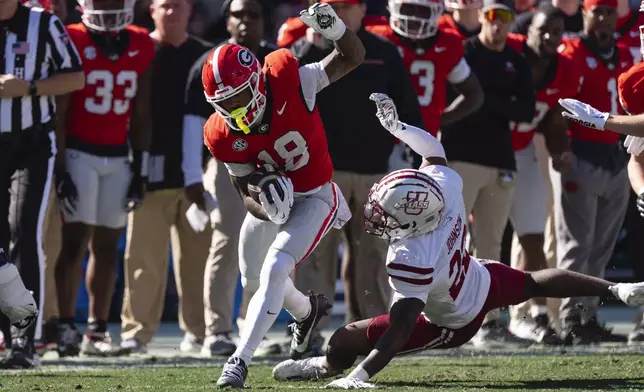 Georgia wide receiver Sacovie White (18) runs past UMass linebacker Gerrell Johnson (22) after a catch during the first half of an NCAA college football game, Saturday, Nov. 23, 2024, in Athens, Ga. (AP Photo/John Bazemore)