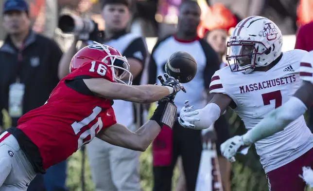 UMass defensive back Lake Ellis (7) breaks uip a pass intended for Georgia wide receiver London Humphreys (16) during the second half of an NCAA college football game, Saturday, Nov. 23, 2024, in Athens, Ga. (AP Photo/John Bazemore)