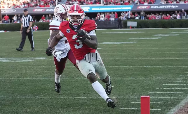 Georgia running back Nate Frazier (3) out runs UMass defensive back Leonard St. Gourdin (11) to the end zone for a tochdown during the second half of an NCAA college football game, Saturday, Nov. 23, 2024, in Athens, Ga. (AP Photo/John Bazemore)