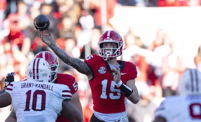 Georgia quarterback Carson Beck (15) throws from the pocket during the second half of an NCAA college football game against UMass, Saturday, Nov. 23, 2024, in Athens, Ga. (AP Photo/John Bazemore)