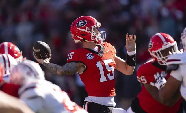 Georgia quarterback Carson Beck (15) throws from the pocket during the first half of an NCAA college football game against UMass, Saturday, Nov. 23, 2024, in Athens, Ga. (AP Photo/John Bazemore)