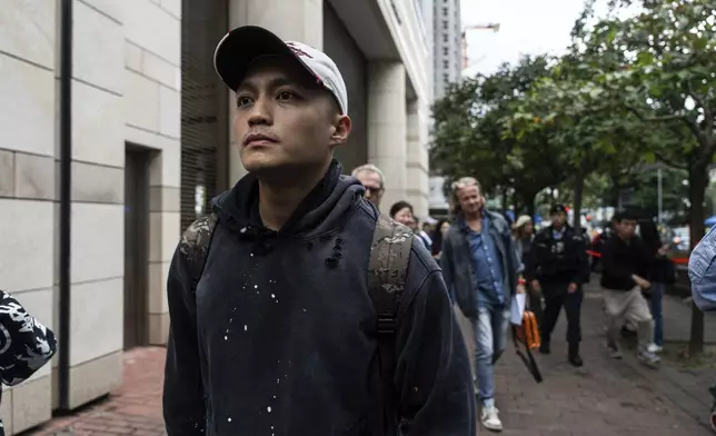 Lee Yue-shun, former pro-democracy district councilor who was cleared of the charge of the national security case, leaves the West Kowloon Magistrates' Courts in Hong Kong Tuesday, Nov. 19, 2024, following the sentencing in national security case. (AP Photo/Chan Long Hei)