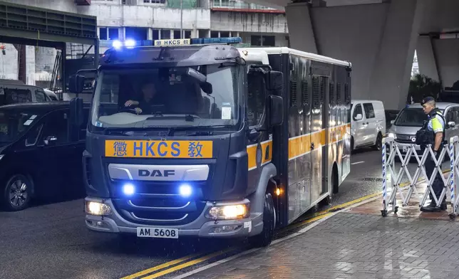 A Correctional Services Department vehicle arrives at the West Kowloon Magistrates' Courts in Hong Kong Tuesday, Nov. 19, 2024, ahead of the sentencing in national security case. (AP Photo/Chan Long Hei)