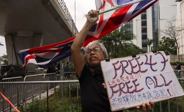 FILE- A pro-democracy activist known as "Grandma Wong" protests outside the West Kowloon courts in a cordoned off area set up by police as closing arguments open in Hong Kong's largest national security trial of 47 pro-democracy figures in Hong Kong, Nov. 29, 2023. (AP Photo/Louise Delmotte, File)