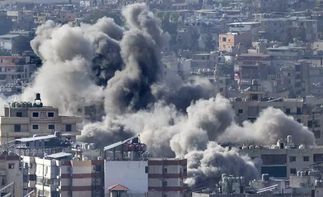 Smoke rises between buildings hit in an Israeli airstrike in Dahiyeh, in the southern suburb of Beirut, Lebanon, Thursday, Nov. 14, 2024. (AP Photo/Hussein Malla)