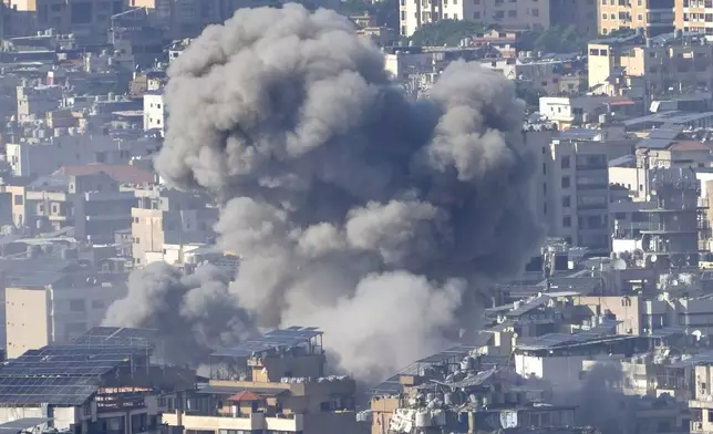 Smoke rises between buildings hit in an Israeli airstrike in Dahiyeh, in the southern suburb of Beirut, Lebanon, Thursday, Nov. 14, 2024. (AP Photo/Hussein Malla)