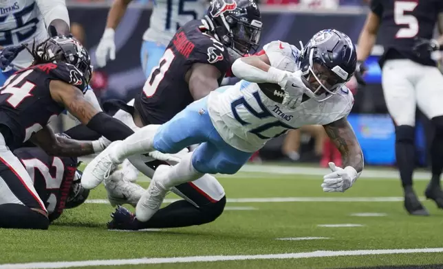 Tennessee Titans running back Tony Pollard (20) dives into the end zone to score a touchdown during the first half of an NFL football game against the Houston Texans, Sunday, Nov. 24, 2024, in Houston. (AP Photo/Eric Christian Smith)