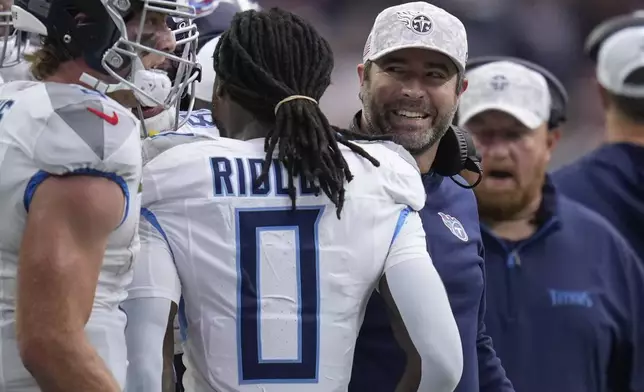 Tennessee Titans head coach Brian Callahan, right, celebrates the team's touchdown during the first half of an NFL football game against the Houston Texans, Sunday, Nov. 24, 2024, in Houston. (AP Photo/Eric Christian Smith)