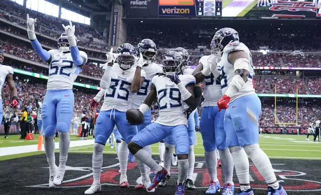 Tennessee Titans cornerback Jarvis Brownlee Jr. (29) celebrates an interception with teammates during the first half of an NFL football game against the Houston Texans, Sunday, Nov. 24, 2024, in Houston. (AP Photo/Eric Christian Smith)