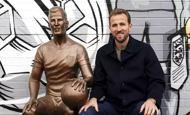 Harry Kane poses during the unveiling of a statue of himself at The Peter May Centre in London, Monday Nov. 18, 2024. (Zac Goodwin/PA via AP)