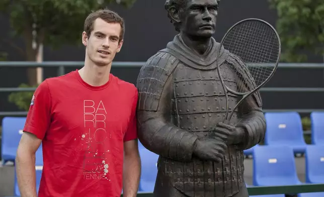 FILE - Andy Murray of Britain poses next to a terracotta warrior sculpture of him after he unveiled it at the Shanghai Masters tennis tournament in Shanghai, China, Tuesday, Oct. 11, 2011. (AP Photo/Andy Wong, File)