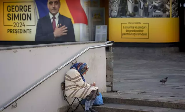 A woman sits on a chair outside the electoral campaign headquarters of George Simion, the Alliance for the Unity of Romanians candidate in the upcoming Nov. 24 presidential elections, in Bucharest, Romania, Friday, Sept. 20, 2024. (AP Photo/Andreea Alexandru)