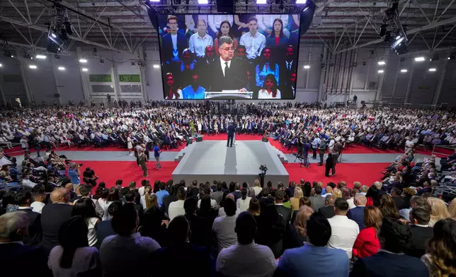 Romanian Prime Minister Marcel Ciolacu addresses delegates at the congress of the Social Democratic Party or PSD, which nominated him as the party's candidate in the upcoming Nov. 24 presidential elections in Bucharest, Romania, Saturday, Aug. 24, 2024. (AP Photo/Andreea Alexandru)