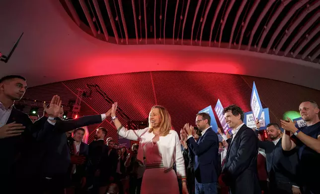 Elena Lasconi, the Save Romania Union or USR, party candidate in the upcoming Nov. 24 presidential elections, greets supporters at an event for launching the party's program in Bucharest, Romania, Sunday, Nov. 3, 2024. (AP Photo/Andreea Alexandru)