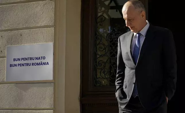 Former NATO Deputy Secretary General Mircea Geoana, who runs as an independent candidate in the upcoming Nov. 24 presidential elections, waits outside his campaign headquarters in Bucharest, Romania, Thursday, Nov. 7, 2024. (AP Photo/Andreea Alexandru)