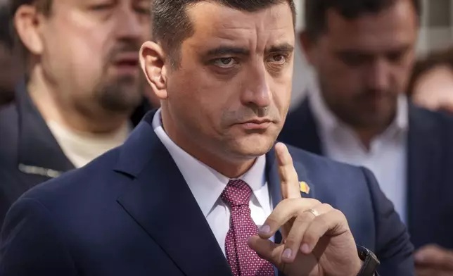 George Simion, the Alliance for the Unity of Romanians or AUR candidate in the upcoming Nov. 24 presidential elections, gestures during a press conference in Bucharest, Romania, Thursday, Oct. 17, 2024. (AP Photo/Andreea Alexandru)